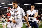 ARLINGTON, TX - SEPTEMBER 05:  Quarterback Sam Bradford #14 of the Oklahoma Sooners walks off the field past Jeremy Beal #44 after a 14-13 loss against the Brigham Young Cougars at Cowboys Stadium on September 5, 2009 in Arlington, Texas.  Bradford suffered an injury in the second quarter and did not return to the game.  (Photo by Ronald Martinez/Getty Images)