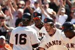 SAN FRANCISCO - AUGUST 30:  Edgar Renteria #16 of the San Francisco Giants is congratulated by Fred Lewis #14, Arron Rowand #33 and Juan Uribe #5 after Renteria hit a grand slam home run that scored them all and gave them a 6-5 lead over the Colorado Rockies ini the seventh inning at AT&T Park on August 30, 2009 in San Francisco, California.  (Photo by Ezra Shaw/Getty Images)