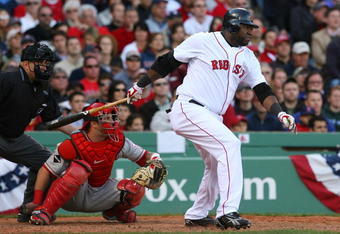 BOSTON - OCTOBER 11:  David Ortiz #34 of the Boston Red Sox hits a single in the eighth inning against the Los Angeles Angels of Anaheim in Game Three of the ALDS during the 2009 MLB Playoffs at Fenway Park on October 11, 2009 in Boston,  Massachusetts. The single by Ortiz was his first hit of the series. (Photo by Jim Rogash/Getty Images)