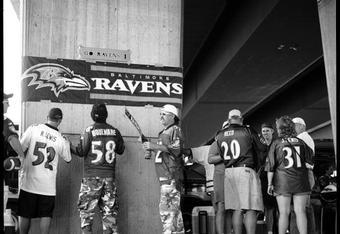 BALTIMORE - SEPTEMBER 23:  Tailgaters take down their teams banners as the prepare to go in to watch the NFL game between the Baltimore Ravens and the Arizona Cardinals on September 23, 2007 at M&T Bank Stadium in Baltimore, Maryland.Born and bred into American sporting culture the act of tailgating is a tradition practiced unlike anywhere else in the world. Tailgating by definition is the act of partying or picnicking around a vehicle in a car park prior to the start of a sporting event. At any major sporting event in the United States you will find die hard fans, all settling into car parks surrounding the stadium, hours before the event even begins. Tailgaters, young and old drink, play games, barbeque and party, rain, hail or snow and often in unusual places, just about anywhere it?s possible to park a car and setup a barbeque. What started as a small pre-game picnic held out of the back of a pickup truck has now evolved into a multibillion-dollar business, with participant numbers estimated at over 50 mi
