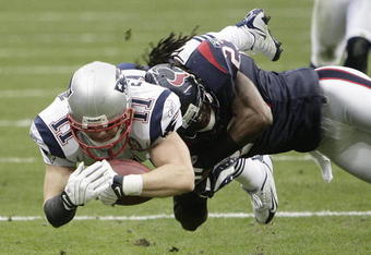 HOUSTON - JANUARY 03:  Wide receiver Julian Edelman #11 of the New England Patriots is tackled by cornerback Dunta Robinson #23 of the Houston Texans short of the goalline at Reliant Stadium on January 3, 2010 in Houston, Texas.  (Photo by Bob Levey/Getty Images)