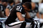 OAKLAND, CA - JANUARY 03:  Nnamdi Asomugha #21 of the Oakland Raiders sits on the bench against the Baltimore Ravens during an NFL game at Oakland-Alameda County Coliseum on January 3, 2010 in Oakland, California.  (Photo by Jed Jacobsohn/Getty Images)
