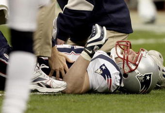 HOUSTON - JANUARY 03:  Wide receiver Wes Welker #83 of the New England Patriots is tended to by medical personnel after injuring his leg against the Houston Texans at Reliant Stadium on January 3, 2010 in Houston, Texas.  (Photo by Bob Levey/Getty Images)