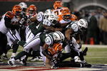EAST RUTHERFORD, NJ - JANUARY 03:  Bart Scott #57 of the New York Jets takes down Larry Johnson #27 of the Cincinnati Bengals with the help of the defensive line during the second half of the game at Giants Stadium on January 3, 2010 in East Rutherford, New Jersey. The Jets defeated the Bengals 37-0.  (Photo by Jeff Zelevansky/Getty Images)