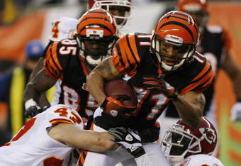CINCINNATI - DECEMBER 27: Laveranues Coles #11 of the Cincinnati Bengals is tackled by Jon McGraw #47 and Travis Daniels #34 of the Kansas City Chiefs in their NFL game at Paul Brown Stadium December 27, 2009 in Cincinnati, Ohio.    (Photo by John Sommers II/Getty Images)