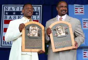 COOPERSTOWN, NY - JULY 26:  2009 inductees Rickey Henderson (L) and Jim Rice pose for a photograph with their plaques at Clark Sports Center during the Baseball Hall of Fame induction ceremony on July 26, 2009 in Cooperstown, New York. Henderson is the all-time leader in stolen bases (1,406) and runs (2,295), a ten time All-Star, was the 1990 American League most valuable player and won two World Series titles. Rice played his entire sixteen year career with the Boston Red Sox, was the 1978 American League most valuable player and was a eight time All-Star.  (Photo by Jim McIsaac/Getty Images)