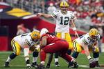 GLENDALE, AZ - JANUARY 03:  Quarterback Aaron Rodgers #12 of the Green Bay Packers points while under center against the Arizona Cardinals at University of Phoenix Stadium on January 3, 2010 in Glendale, Arizona.  (Photo by Maxx Wolfson/Getty Images)