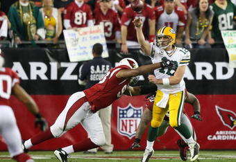 GLENDALE, AZ - JANUARY 10:  Quarterback Aaron Rodgers #12 of the Green Bay Packers throws a pass under pressure from Calais Campbell #93 of the Arizona Cardinals during overtime of the 2010 NFC wild-card playoff game at the Universtity of Phoenix Stadium on January 10, 2010 in Glendale, Arizona.  The Cardinals defeated the Packers  51-45 in overtime.  (Photo by Christian Petersen/Getty Images)