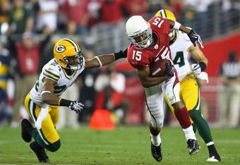 GLENDALE, AZ - JANUARY 10:  Wide receiver Steve Breaston #15 of the Arizona Cardinals runs with the ball past Jarrett Bush #24 of the Green Bay Packers during the 2010 NFC wild-card playoff game at the Universtity of Phoenix Stadium on January 10, 2010 in Glendale, Arizona.  The Cardinals defeated the Packers  51-45 in overtime.  (Photo by Christian Petersen/Getty Images)