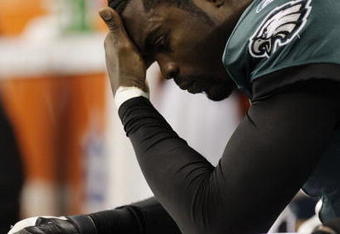 ARLINGTON, TX - JANUARY 9:  Quarterback Michael Vick #7 of the Philadelphia Eagles looks down on the bench late in the fourth quarter against the Dallas Cowboys during the 2010 NFC wild-card playoff game at Cowboys Stadium on January 9, 2010 in Arlington, Texas. (Photo by Jamie Squire/Getty Images)
