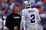 EAST RUTHERFORD, NJ - OCTOBER 11: Head Coach Tom Cable and JaMarcus Russell #2 of the Oakland Raiders talk inbetween plays during the game on October 11, 2009 at Giants Stadium in East Rutherford, New Jersey. (Photo by Jared Wickerham/Getty Images)