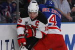 NEW YORK, NY - OCTOBER 22:  Jamie Langenbrunner #15 of the New Jersey Devils handles the puck as Michael Del Zotto #4 of the New York Rangers defends during their game on October 22, 2009 at Madison Square Garden in New York City, New York.  (Photo by Al Bello/Getty Images)