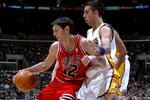 LOS ANGELES, CA - NOVEMBER 20:  Kirk Hinrich #12 of the Chicago Bulls spins as he drives against Sasha Vujacic #18 of the Los Angeles Lakers November 20, 2005 at Staples Center in Los Angeles, California.  NOTE TO USER: User expressly acknowledges and agrees that, by downloading and/or using this Photograph, user is consenting to the terms and conditions of the Getty Images License Agreement  (Photo by Jeff Gross/Getty Images)