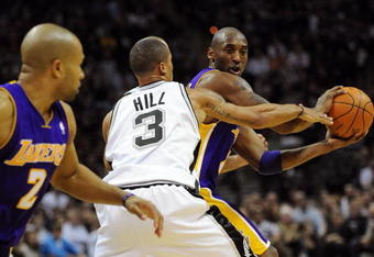 SAN ANTONIO - JANUARY 12:  Guard Kobe Bryant #24 of the Los Angeles Lakers dribbles the ball against George Hill #3 of the San Antonio Spurs on January 12, 2010 at AT&T Center in San Antonio, Texas.  NOTE TO USER: User expressly acknowledges and agrees that, by downloading and/or using this Photograph, user is consenting to the terms and conditions of the Getty Images License Agreement.  (Photo by Ronald Martinez/Getty Images)