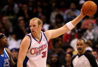 LOS ANGELES, CA - OCTOBER 31:  Chris Kaman #35 of the Los Angeles Clippers controls the ball against Erick Dampier #25 of the Dallas Mavericks on October 31, 2009 at Staples Center in Los Angeles, California. Dallas won 93-84.   NOTE TO USER: User expressly acknowledges and agrees that, by downloading and/or using this Photograph, user is consenting to the terms and conditions of the Getty Images License Agreement.  (Photo by Stephen Dunn/Getty Images)