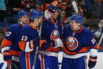 UNIONDALE, NY - DECEMBER 27:  Jon Sim #16 of the New York Islanders celebrates his goal with team mates Rob Schremp #13 and Andrew McDonald #47 against the Philadelphia Flyers on December 27, 2009 at the Nassau Coliseum in Uniondale, New York.  (Photo by Chris McGrath/Getty Images)