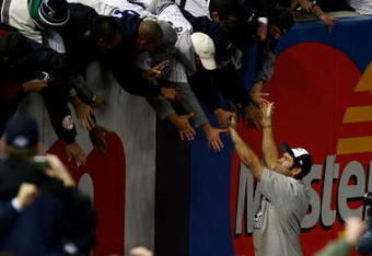 NEW YORK - NOVEMBER 04:  Johnny Damon #18 of the New York Yankees celebrates with fans in the outfield after their 7-3 win against the Philadelphia Phillies in Game Six of the 2009 MLB World Series at Yankee Stadium on November 4, 2009 in the Bronx borough of New York City.  (Photo by Chris McGrath/Getty Images)