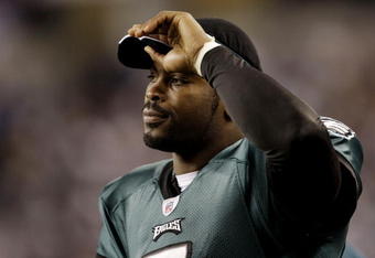 ARLINGTON, TX - JANUARY 9:  Michael Vick #7 of the Philadelphia Eagles looks on from the sideline in the second quarter against the Dallas Cowboys during the 2010 NFC wild-card playoff game at Cowboys Stadium on January 9, 2010 in Arlington, Texas. (Photo by Jamie Squire/Getty Images)