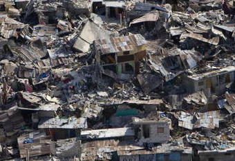 PORT-AU-PRINCE, HAITI - JANUARY 13:  In this handout image provided by the United Nations, Houses in a  poor neighborhood sit destroyed after an earthquake on January 13, 2010 in Port-au-Prince, Haiti. Planeloads of rescuers and relief supplies headed to Haiti as governments and aid agencies launched a massive relief operation after a powerful earthquake killing possibly thousands. Numerous buildings were reduced to rubble by the 7.0-strong quake on January 12.  (Photo by Logan Abassi/MINUSTAH via Getty Images)