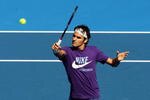 MELBOURNE, AUSTRALIA - JANUARY 14:  Roger Federer of Switzerland reaches for a backhand volley during a practice session ahead of the 2010 Australian Open at Melbourne Park on January 14, 2010 in Melbourne, Australia.  (Photo by Mark Dadswell/Getty Images)