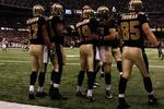 NEW ORLEANS - JANUARY 16:  Devery Henderson #19 and Drew Brees of the New Orleans Saints celebrate along with teammates after they connected for 44-yard touchdown reception in the second quarter against the Arizona Cardinals during the NFC Divisional Playoff Game at Louisana Superdome on January 16, 2010 in New Orleans, Louisiana.  (Photo by Chris Graythen/Getty Images)