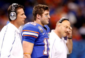NEW ORLEANS - JANUARY 01:  (L-R) Head Coach Urban Meyer Tim Tebow #15 and Offensive coordinator and interim head coach Steve Addazio of the Florida Gators watches from the sidelines during the Allstate Sugar Bowl against the Cincinnati Bearcats at the Louisana Superdome on January 1, 2010 in New Orleans, Louisiana.  (Photo by Kevin C. Cox/Getty Images)