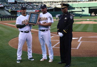 OAKLAND, CA - APRIL 10:  Jason Giambi #16 and Eric Chavez #3 of the Oakland Athletics present a plaque to Oakland Police Chief Howard Jordan, honoring four officers who were slain last month, before the Seattle Mariners and the Oakland Athletics Opening Day Major League Baseball game on April 10, 2009 at the Oakland Coliseum in Oakland, California.  (Photo by Jed Jacobsohn/Getty Images)