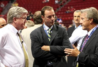 MONTREAL, QC - JUNE 26:  President & General Manager Brian Burke (L) and head coach Ron Wilson (R) of the Toronto Maple Leafs talk with Genral Manager Joe Nieuwendyk of the Dallas Stars prior to the first round of the 2009 NHL Entry Draft at the Bell Centre on June 26, 2009 in Montreal, Quebec, Canada.  (Photo by Bruce Bennett/Getty Images)