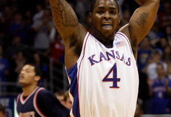 LAWRENCE, KS - DECEMBER 29:  Sherron Collins #4 of the Kansas Jayhawks reacts after scoring during the game against the Belmont Bruins on December 29, 2009 at Allen Fieldhouse in Lawrence, Kansas.  (Photo by Jamie Squire/Getty Images)