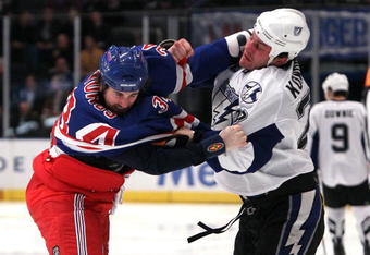 NEW YORK - JANUARY 19:  Zenon Konopka #28 of the Tampa Bay Lightning trades punches against Aaron Voros #34 of the New York Rangers during the first period on January 19, 2010 at Madison Square Garden in New York City.  (Photo by Jim McIsaac/Getty Images)