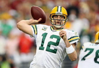 GLENDALE, AZ - JANUARY 10:  Quarterback Aaron Rodgers #12 of the Green Bay Packers throws a pass during the 2010 NFC wild-card playoff game against  the Arizona Cardinals at the Universtity of Phoenix Stadium on January 10, 2010 in Glendale, Arizona.  The Cardinals defeated the Packers  51-45 in overtime.  (Photo by Christian Petersen/Getty Images)