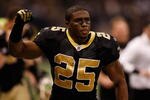 NEW ORLEANS - JANUARY 16:  Reggie Bush #25 of the New Orleans Saints gestures as he runs off the field at hlaftime against the Arizona Cardinals during the NFC Divisional Playoff Game at Louisana Superdome on January 16, 2010 in New Orleans, Louisiana.  (Photo by Chris Graythen/Getty Images)