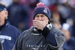 FOXBORO, MA - JANUARY 10:  Head coach Bill Belichick of the New England Patriots covers his mouth as he looks on against the Baltimore Ravens during the 2010 AFC wild-card playoff game at Gillette Stadium on January 10, 2010 in Foxboro, Massachusetts.  (Photo by Al Bello/Getty Images)