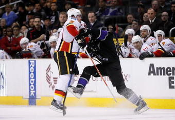 LOS ANGELES, CA - DECEMBER 07:  Dion Phaneuf #3 of the Calgary Flames hits Justin Williams #14 of the Los Angeles Kings in the second period at Staples Center on December 7, 2009 in Los Angeles, California.  (Photo by Jeff Gross/Getty Images)