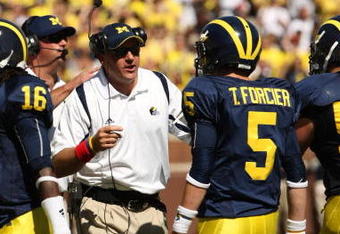 ANN ARBOR, MI - SEPTEMBER 19:  Head coach Rich Rodriguez of the Michigan Wolverines talks with quarterback Tate Forcier #5 during the game with the Eastern Michigan Eagles at Michigan Stadium on September 19, 2009 in Ann Arbor, Michigan.  Michigan won 45-17.  (Photo by Stephen Dunn/Getty Images)