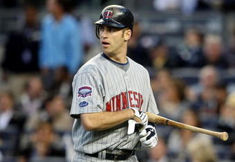 NEW YORK - OCTOBER 07:  Joe Mauer #7 of the Minnesota Twins walks back to the dugout after striking out in the first inning against the New York Yankees in Game One of the ALDS during the 2009 MLB Playoffs at Yankee Stadium on October 7, 2009 in the Bronx borough of New York City.  (Photo by Nick Laham/Getty Images)
