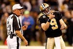 NEW ORLEANS - JANUARY 16:  Quarterback Drew Brees #9 of the New Orleans Saints talks with referee Ron Winter #14 against the Arizona Cardinals during the NFC Divisional Playoff Game at Louisana Superdome on January 16, 2010 in New Orleans, Louisiana. The Saints won 45-14. (Photo by Ronald Martinez/Getty Images)