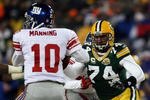 GREEN BAY, WI - JANUARY 20:  Defensive end Aaron Kampman #74 of the Green Bay Packers rushes in at Eli Manning #10 of the New York Giants during the NFC championship game on January 20, 2008 at Lambeau Field in Green Bay, Wisconsin. The Giants defeated the Packers 23-20 in overtime to advance to the Superbowl XLII.  (Photo by Jonathan Daniel/Getty Images)