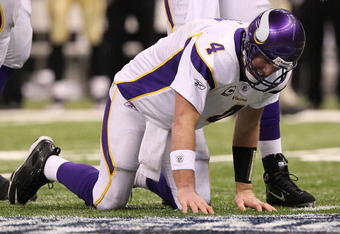 NEW ORLEANS - JANUARY 24:  Brett Favre #4 of  the Minnesota Vikings reacts after taking a hard hit in the second half against the New Orleans Saints during the NFC Championship Game at the Louisiana Superdome on January 24, 2010 in New Orleans, Louisiana.  (Photo by Jed Jacobsohn/Getty Images)