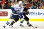 DALLAS - NOVEMBER 06:  Henrik Sedin #33 of the Vancouver Canucks skates the puck past Trevor Daley #6 of the Dallas Stars at American Airlines Center on November 6, 2009 in Dallas, Texas.  (Photo by Ronald Martinez/Getty Images)