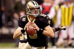 NEW ORLEANS - JANUARY 24:  Drew Brees #9 of the New Orleans Saints rolls out to pass against the Minnesota Vikings during the NFC Championship Game at the Louisana Superdome on January 24, 2010 in New Orleans, Louisiana. The Saints won 31-28 in overtime.  (Photo by Chris Graythen/Getty Images)