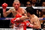 LAS VEGAS - NOVEMBER 14:  A bloodied Miguel Cotto (L) and Manny Pacquiao battle during the 11th round of their WBO welterweight title fight at the MGM Grand Garden Arena on November 14, 2009 in Las Vegas, Nevada. Pacquiao defeated Cotto by TKO in the 12th round.  (Photo by Ethan Miller/Getty Images)