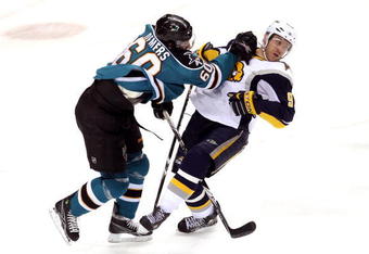 SAN JOSE, CA - JANUARY 23: Derek Roy #9 of the Buffalo Sabres is hit by Jason Demers #60 of the San Jose Sharks at HP Pavilion on January 23, 2010 in San Jose, California. (Photo by Ezra Shaw/Getty Images)