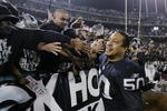 OAKLAND, CA - JANUARY 19:  Linebacker Eric Barton #50 of the Oakland Raiders celebrates with fans in the Black Hole after the 41-24 victory over the Tennessee Titans in the AFC Championship game at Network Associates Coliseum on January 19, 2003 in Oakland, California.  The Raiders moved on to the NFL title game for the first time since 1984.  (Photo by Jed Jacobsohn/Getty Images)