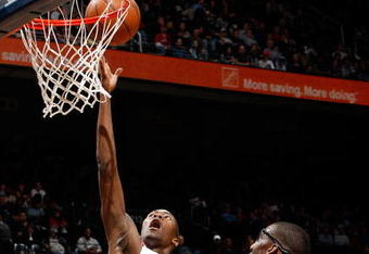 ATLANTA - JANUARY 15:  Jamal Crawford #11 of the Atlanta Hawks lays in a basket against Amare Stoudemire #1 of the Phoenix Suns at Philips Arena on January 15, 2010 in Atlanta, Georgia.  NOTE TO USER: User expressly acknowledges and agrees that, by downloading and/or using this Photograph, User is consenting to the terms and conditions of the Getty Images License Agreement.  (Photo by Kevin C. Cox/Getty Images)