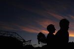 MELBOURNE, AUSTRALIA - JANUARY 23:  Spectators enjoy the atmosphere at the sun sets over Melbourne Park during day six of the 2010 Australian Open on January 23, 2010 in Melbourne, Australia.  (Photo by Robert Prezioso/Getty Images)