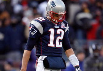 FOXBORO, MA - JANUARY 10:  Tom Brady #12 of the New England Patriots walks with his head down against the Baltimore Ravens during the 2010 AFC wild-card playoff game at Gillette Stadium on January 10, 2010 in Foxboro, Massachusetts.  (Photo by Elsa/Getty Images)
