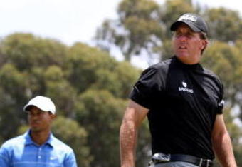 SAN DIEGO - JUNE 12:  Phil Mickelson watches his tee shot on the 18th hole as Tiger Woods looks on  during the first round of the 108th U.S. Open at the Torrey Pines Golf Course (South Course) on June 12, 2008 in San Diego, California.  (Photo by Ross Kinnaird/Getty Images)