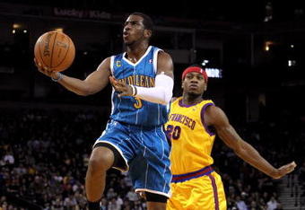 OAKLAND, CA - JANUARY 27:  Chris Paul #3 of the New Orleans Hornets drives on Cartier Martin #20 of the Golden State Warriors at Oracle Arena on January 27, 2010 in Oakland, California.  NOTE TO USER: User expressly acknowledges and agrees that, by downloading and/or using this Photograph, user is consenting to the terms and conditions of the Getty Images License Agreement.  (Photo by Ezra Shaw/Getty Images)