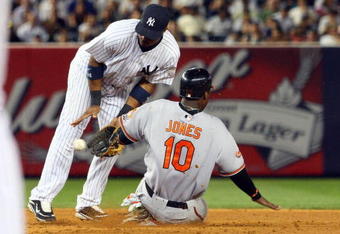 NEW YORK - JULY 20:  Adam Jones #10 of the Baltimore Orioles steals second base against Robinson Cano #24 of the New York Yankees on July 20, 2009 at Yankee Stadium in the Bronx borough of New York City. The Yankees defeated the Orioles 2-1.  (Photo by Jim McIsaac/Getty Images)